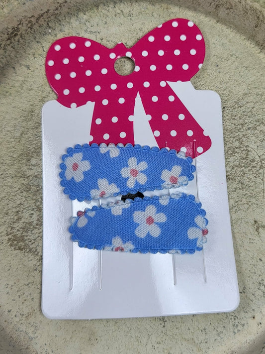 Baby klikspeld blauw met witte bloemen