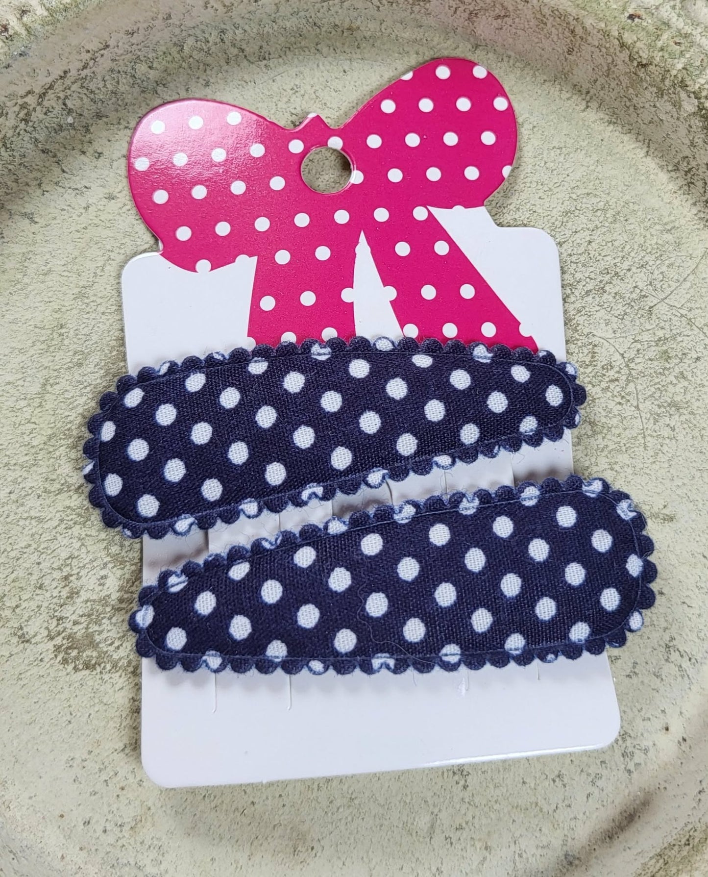 Kind klikspeld donkerblauw met witte stippen