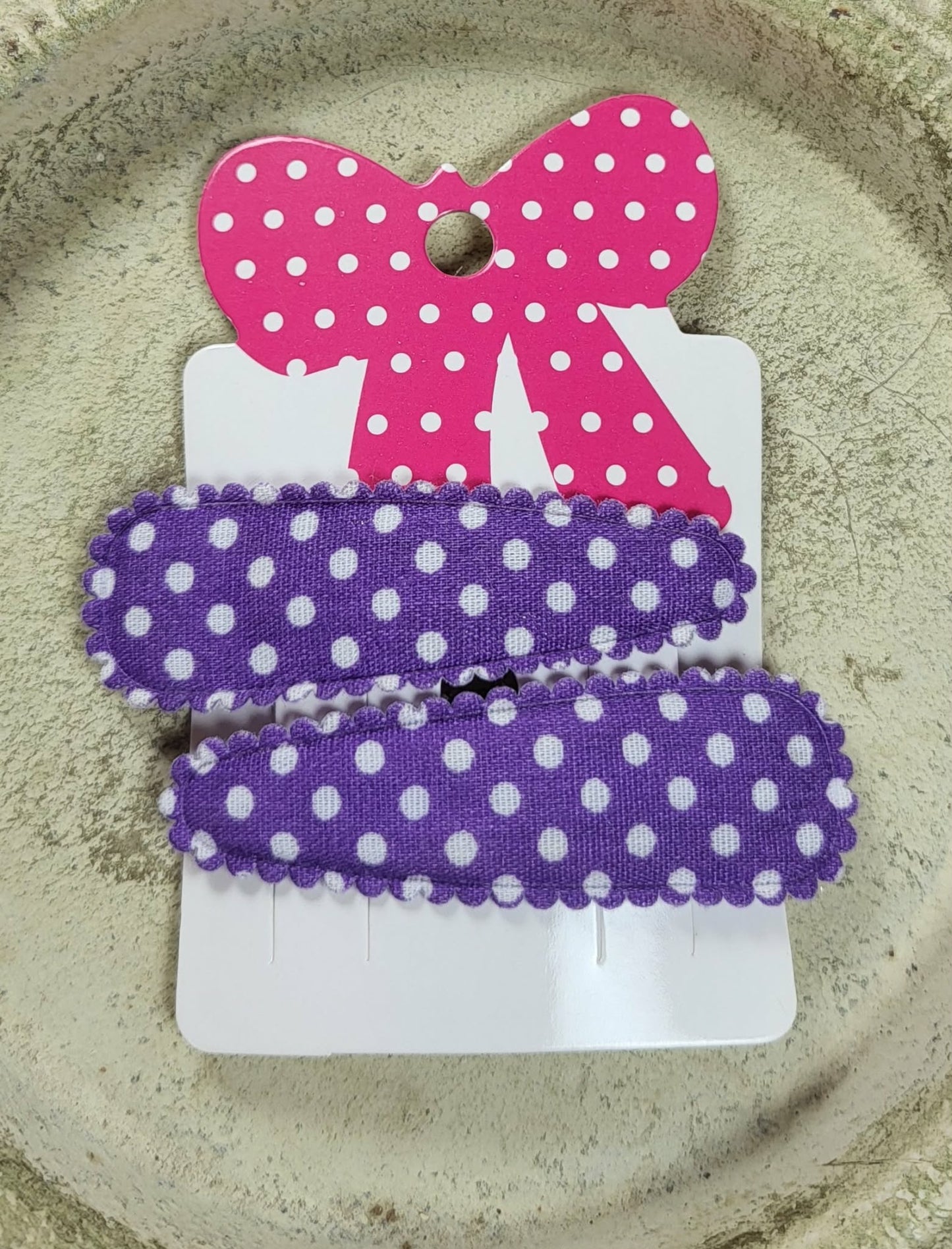 Kind klikspeld paars met witte stippen